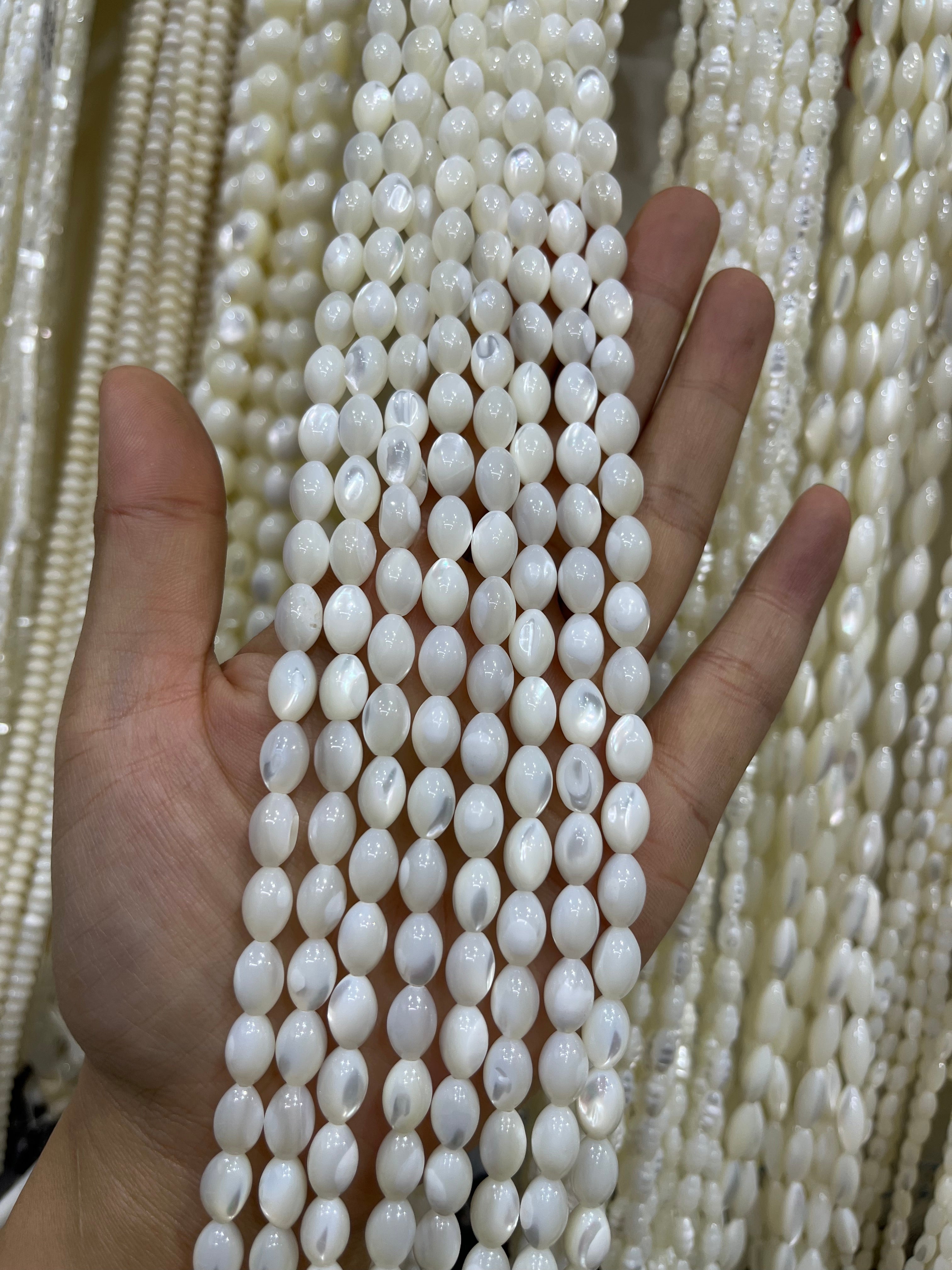 white shell drum beads strand