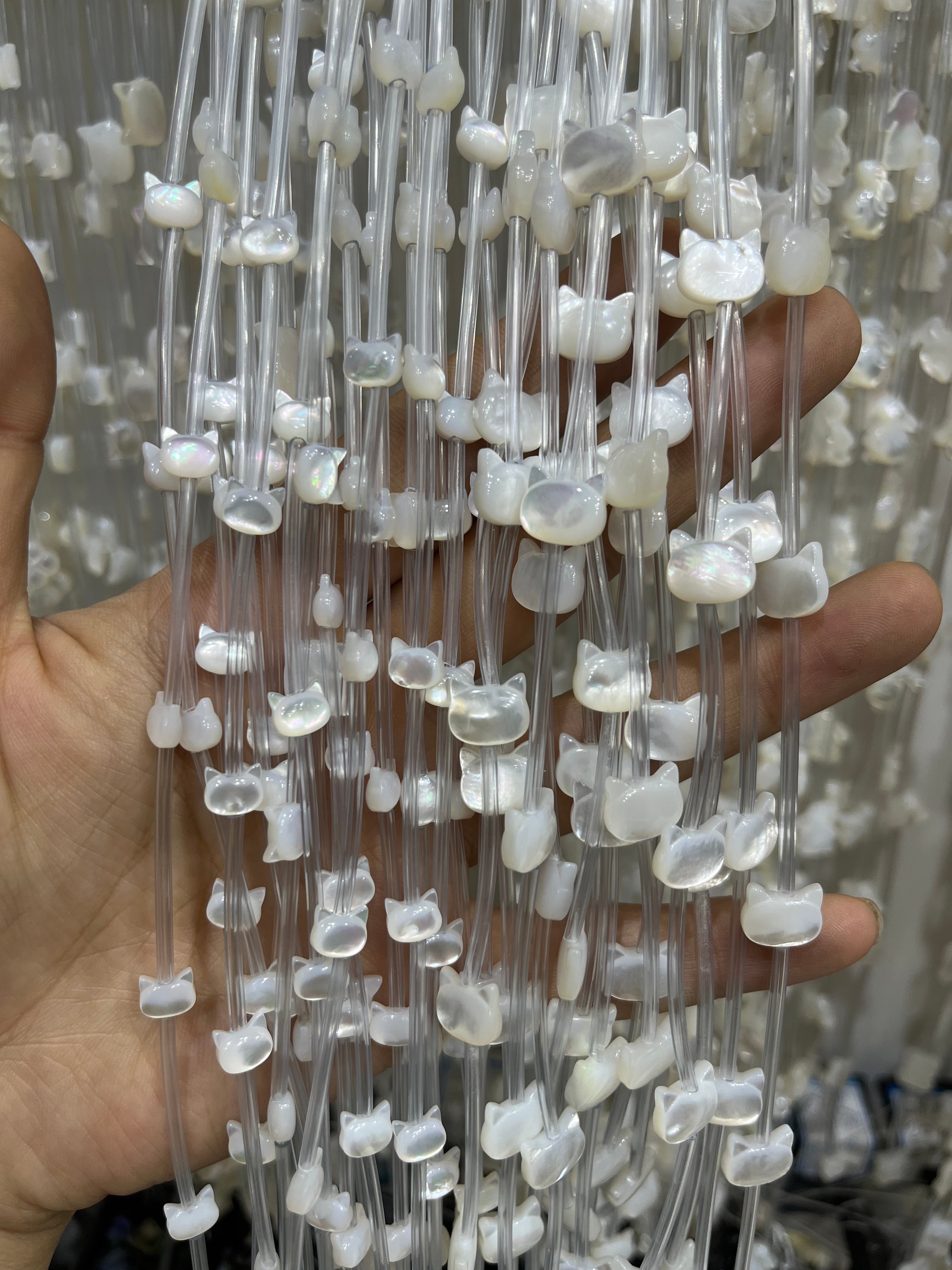 white shell cat head beads strand